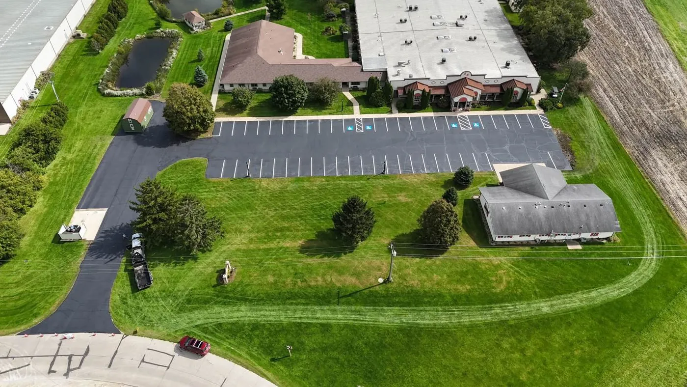 Commercial parking lot in Iowa sealcoated with fresh white line striping and handicap stalls